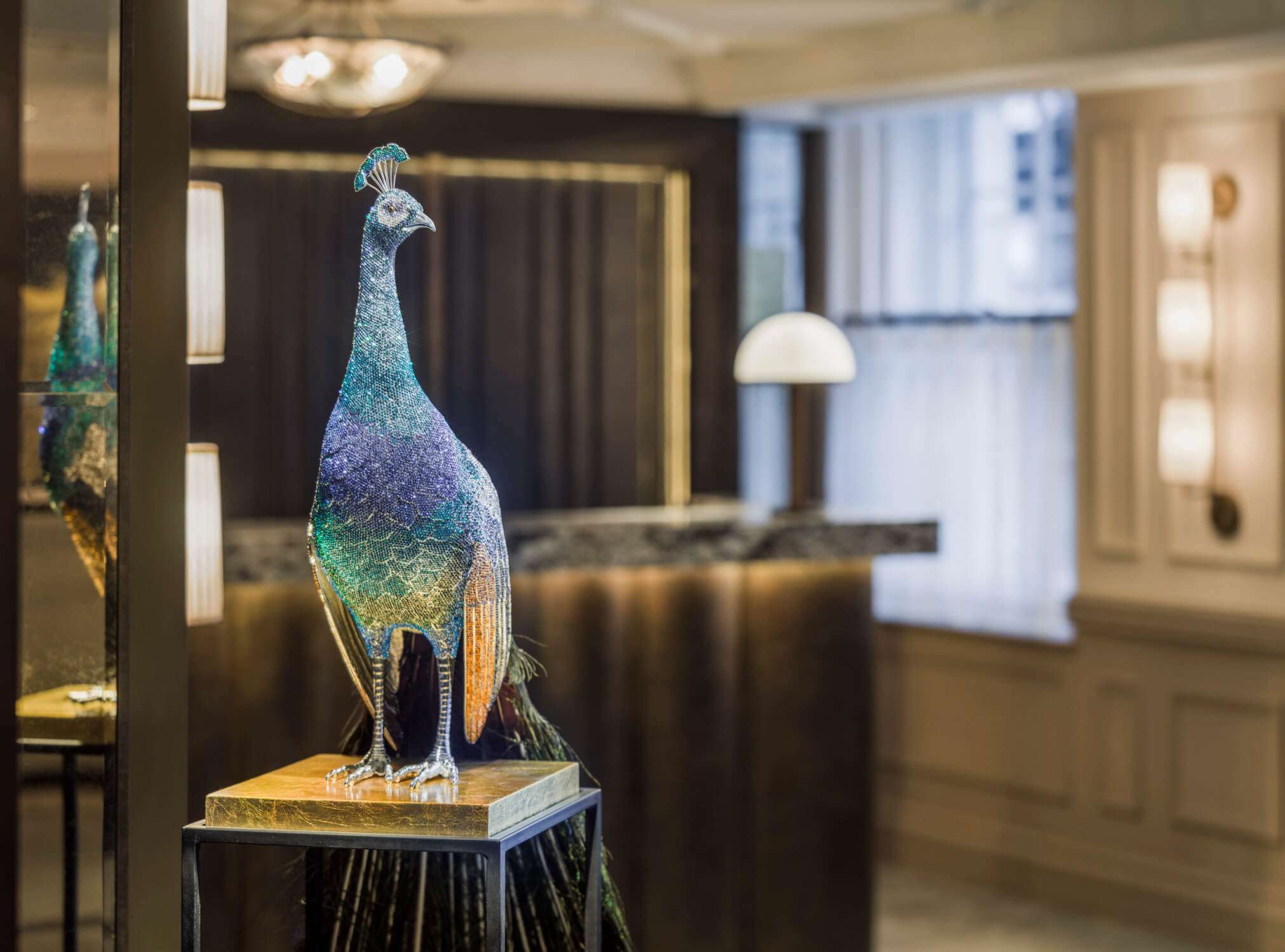 Close up of peacock sculpture in the lobby at The Mayfair Townhouse